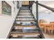 Staircase with wooden steps leading to living area, view of dining area, and natural light at 200 Maitland Ave # 52, Altamonte Springs, FL 32701