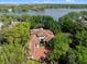 Large lakefront home with lush landscaping and a circular driveway at 2001 Bett Mar Ln, Winter Park, FL 32789