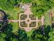 Aerial view of a formal garden with brick paths, lush greenery, and unique garden structure at 2001 Bett Mar Ln, Winter Park, FL 32789
