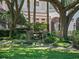 Serene backyard featuring an outdoor dining area with a wooden table and chairs, surrounded by trees at 2001 Bett Mar Ln, Winter Park, FL 32789