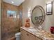Bathroom with a walk-in shower with tile surround, decorative mirror and a single vanity at 2001 Bett Mar Ln, Winter Park, FL 32789