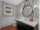 Stylish bathroom featuring decorative wallpaper, a modern vanity, and a framed mirror at 2001 Bett Mar Ln, Winter Park, FL 32789