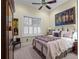 Comfortable bedroom featuring a queen-sized bed, vintage artwork, and a bright window with white shutters at 2001 Bett Mar Ln, Winter Park, FL 32789