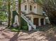 Charming exterior featuring a fountain, unique staircase, manicured landscaping, and a brick driveway at 2001 Bett Mar Ln, Winter Park, FL 32789