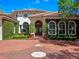 Charming home with lush green landscaping, an inviting entrance, and a brick driveway leading up to the property at 2001 Bett Mar Ln, Winter Park, FL 32789