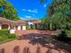 Stunning home with a meticulously landscaped front yard and a brick driveway leading to a multi-car garage at 2001 Bett Mar Ln, Winter Park, FL 32789