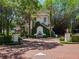 Charming home exterior with a unique fountain feature, manicured landscaping, and a beautiful brick driveway at 2001 Bett Mar Ln, Winter Park, FL 32789