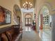 Welcoming foyer with a high ceiling, elegant chandelier, and a clear view to the outdoors at 2001 Bett Mar Ln, Winter Park, FL 32789