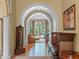 Elegant foyer with arched doorways and view to the outdoor living area at 2001 Bett Mar Ln, Winter Park, FL 32789