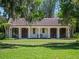 Charming home with white columns, a red tile roof and a well manicured lawn at 2001 Bett Mar Ln, Winter Park, FL 32789