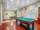 Spacious game room featuring a billiard table, hardwood floors, and unique deer head decorations at 2001 Bett Mar Ln, Winter Park, FL 32789