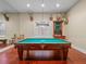 Bright game room featuring a billiard table, hardwood floors, and unique deer head decorations at 2001 Bett Mar Ln, Winter Park, FL 32789