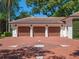 Spacious three-car garage with brick driveway showcasing a decorative compass rose at 2001 Bett Mar Ln, Winter Park, FL 32789