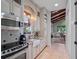 Modern kitchen with granite counters, stainless steel appliances, and hardwood floors, leading into the living room at 2001 Bett Mar Ln, Winter Park, FL 32789
