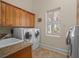 Charming laundry room features laundry machines, granite countertop, and ample storage at 2001 Bett Mar Ln, Winter Park, FL 32789