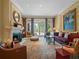 Inviting living room with a fireplace, plush seating, and French doors leading to the outdoors at 2001 Bett Mar Ln, Winter Park, FL 32789