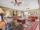Elegant living room with tray ceiling, fans, and bold patterned furniture at 2001 Bett Mar Ln, Winter Park, FL 32789