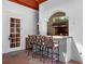 Covered patio with a built-in bar and seating for outdoor entertaining at 2001 Bett Mar Ln, Winter Park, FL 32789