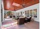 Bright sunroom with wood ceiling, skylight, ceiling fans, and tile flooring at 2001 Bett Mar Ln, Winter Park, FL 32789