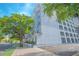 Modern condo building with a parking garage, street view, and surrounding greenery, perfect for urban living at 204 E South St # 2061, Orlando, FL 32801