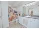 Well-lit bathroom features updated fixtures, modern vanity, and patterned shower curtain at 204 E South St # 2061, Orlando, FL 32801