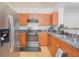 Contemporary kitchen featuring stainless steel appliances and wood cabinets at 204 E South St # 2061, Orlando, FL 32801