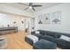 Open living area with a dark couch, ceiling fan, and wood-look floors at 204 E South St # 2061, Orlando, FL 32801