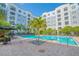 Community pool area with lounge chairs and palm trees at 204 E South St # 2061, Orlando, FL 32801