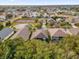 Expansive aerial view of a residential community featuring well-maintained homes, green spaces, and recreational facilities like tennis courts at 213 Hideaway Beach Ln, Kissimmee, FL 34746