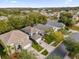 Beautiful aerial view of a residential neighborhood with mature trees and lush landscaping at 213 Hideaway Beach Ln, Kissimmee, FL 34746