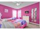 Colorful bedroom with twin beds, a dresser, and fun decor at 213 Hideaway Beach Ln, Kissimmee, FL 34746