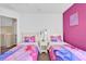 Charming bedroom with two twin beds adorned with princess-themed bedding at 213 Hideaway Beach Ln, Kissimmee, FL 34746
