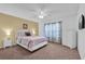 Cozy bedroom with carpet, a ceiling fan, and natural light filtering through patterned curtains at 213 Hideaway Beach Ln, Kissimmee, FL 34746