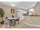 Bright dining area features a modern table, chandelier, and flows into the kitchen at 213 Hideaway Beach Ln, Kissimmee, FL 34746