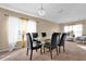Bright dining room featuring a glass table, black chairs, and an elegant chandelier at 213 Hideaway Beach Ln, Kissimmee, FL 34746