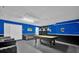 Spacious game room with pool table, stylish sofa, and sleek black and blue walls at 213 Hideaway Beach Ln, Kissimmee, FL 34746