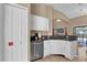 Modern kitchen featuring granite countertops, stainless appliances and white cabinets at 213 Hideaway Beach Ln, Kissimmee, FL 34746