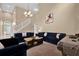 Bright living room featuring high ceilings, a chandelier, plush sofas, and staircase at 213 Hideaway Beach Ln, Kissimmee, FL 34746