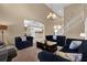 Expansive living room offering comfortable seating, stylish decor, and seamless kitchen access at 213 Hideaway Beach Ln, Kissimmee, FL 34746