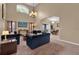 Open-concept living room featuring plush seating, media console, and seamless access to dining area at 213 Hideaway Beach Ln, Kissimmee, FL 34746