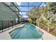 Sparkling pool surrounded by a screened enclosure at 213 Hideaway Beach Ln, Kissimmee, FL 34746