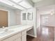 Bathroom featuring long vanity with sink, large mirror, and hardwood floors at 2309 Sun Valley Cir # 2309, Winter Park, FL 32792