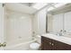 Bathroom featuring tiled shower and tub, wood vanity and framed mirror, and natural light at 2309 Sun Valley Cir # 2309, Winter Park, FL 32792