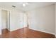 Bright bedroom features hardwood floors, ceiling fan, and access to additional rooms via white doors at 2309 Sun Valley Cir # 2309, Winter Park, FL 32792
