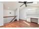 Bedroom with built-in desk and shelving, ceiling fan, skylight, and hardwood floors at 2309 Sun Valley Cir # 2309, Winter Park, FL 32792