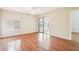 Bright bedroom features hardwood floors, a ceiling fan, and a sliding glass door to the lanai at 2309 Sun Valley Cir # 2309, Winter Park, FL 32792