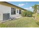 View of the home's exterior with a well-maintained lawn, plants, and clearly visible address number 2309 at 2309 Sun Valley Cir # 2309, Winter Park, FL 32792