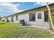 Exterior view with maintained lawn, plants, and visible address number 2309 on the building at 2309 Sun Valley Cir # 2309, Winter Park, FL 32792
