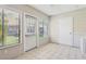 Bright Florida room featuring tile floors, multiple windows, and a door to the outside at 2309 Sun Valley Cir # 2309, Winter Park, FL 32792
