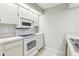 The kitchenette features white cabinets and appliances at 2309 Sun Valley Cir # 2309, Winter Park, FL 32792